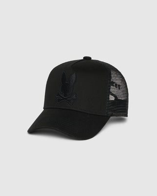 A black trucker hat with a mesh back and an emblem featuring a rabbit skull and crossbones design on the front, complete with snapback fastening for the perfect fit, is the KIDS HOUSTON TRUCKER HAT - B0A550C2HT by Psycho Bunny.