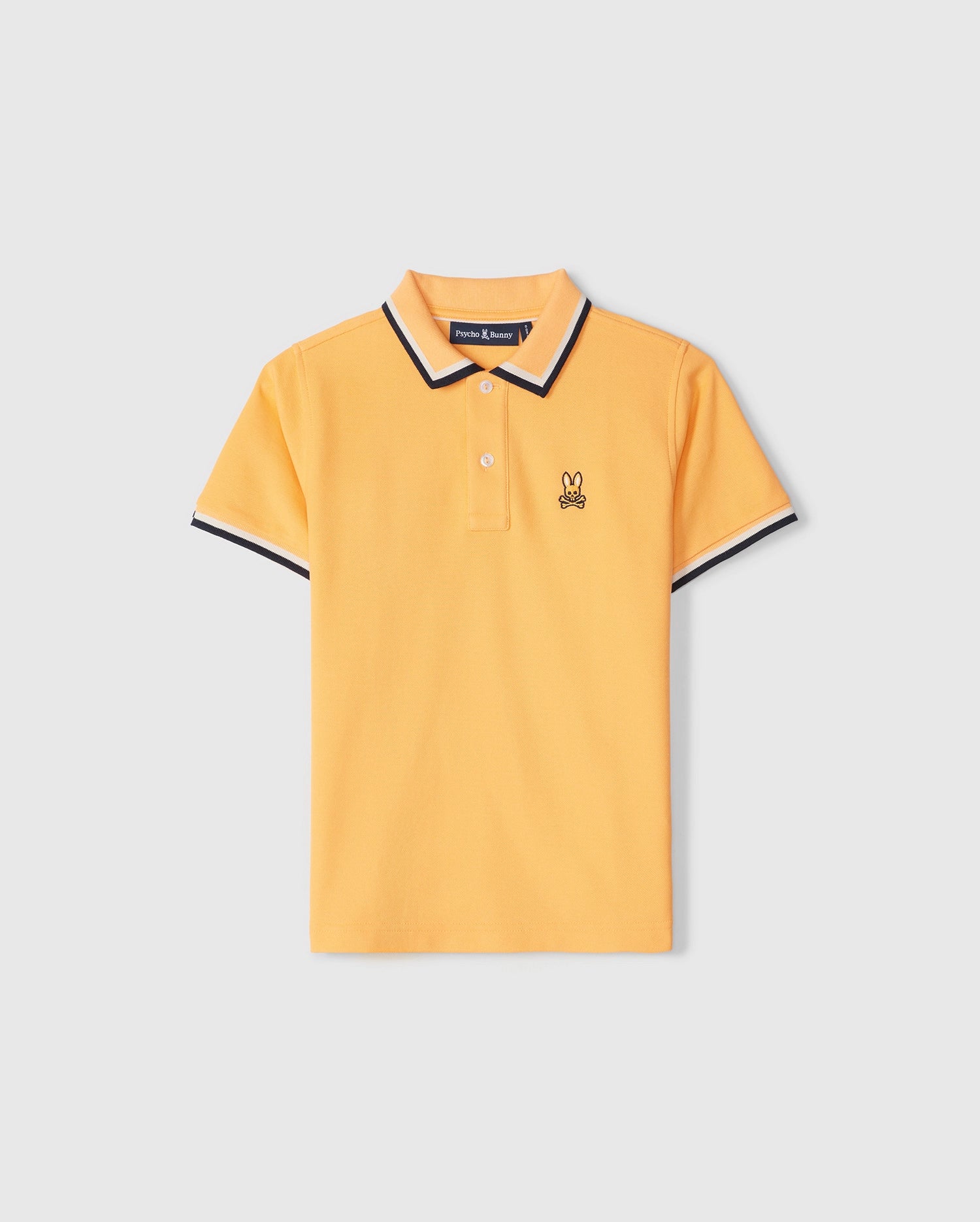 A yellow KIDS KINGSBURY PIQUE POLO SHIRT - B0K235B200 by Psycho Bunny with a classic silhouette, featuring a black and white striped collar and sleeve cuffs. The shirt includes two buttons at the neckline and a small embroidered bunny logo on the left chest.