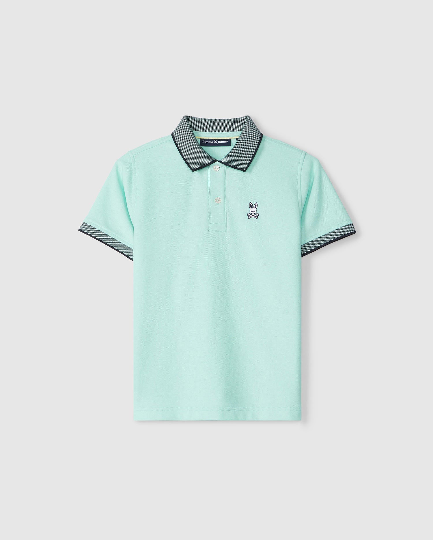 A light green Kids Southport Pique Polo Shirt with a small white bunny logo on the chest and grey accents on the collar and sleeves, displayed against a plain background by Psycho Bunny.