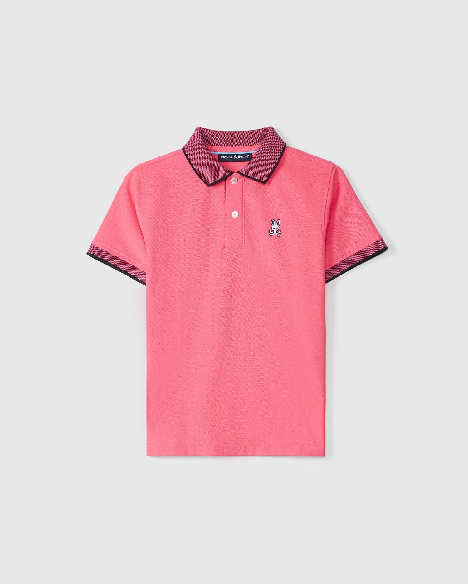 A kids' Psycho Bunny KIDS SOUTHPORT PIQUE POLO SHIRT - B0K263B200, this pink shirt boasts a dark purple collar and sleeve edges. The shirt features a small embroidered rabbit logo on the left chest and has a front button placket with two buttons. Made from Pima cotton piqué, it combines comfort with style for young fashion enthusiasts.