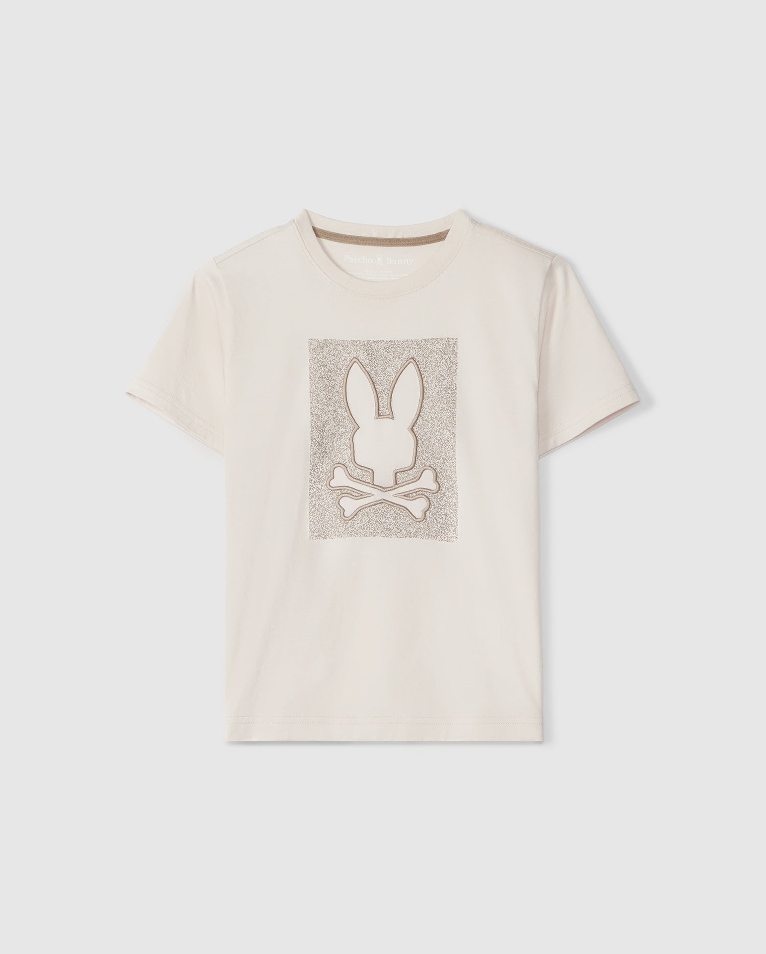A plain, light-colored Psycho Bunny Livingston graphic tee featuring an embroidered Bunny design of a stylized rabbit head above crossed bones within a square frame, set against a plain background.
