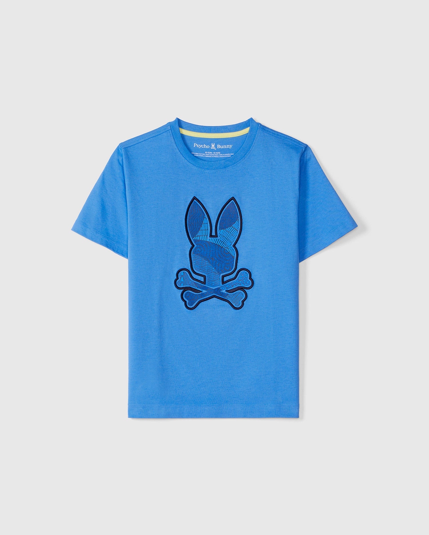 A blue short-sleeve kids' **KIDS LENOX EMBROIDERED GRAPHIC TEE - B0U405B200** made from soft Pima cotton, featuring a black embroidered graphic of a bunny head with crossed bones beneath it on the front. The shirt also has a round neckline. Brand: **Psycho Bunny**.