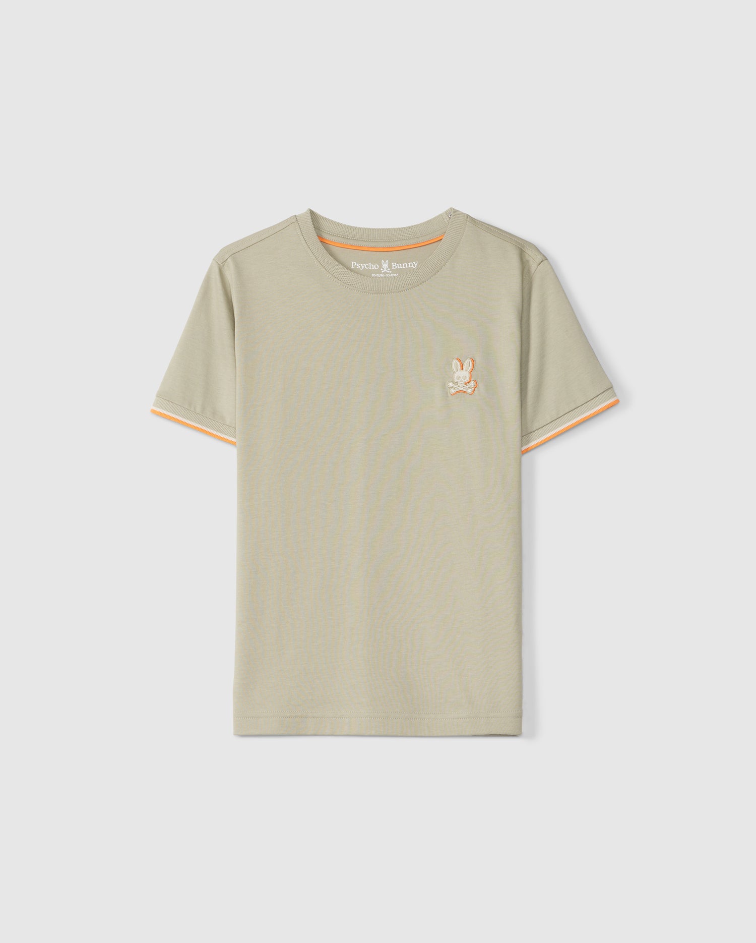 A light beige short-sleeve kids fashion tee made from soft Pima cotton, featuring an embroidered chest bunny logo on the left. The shirt has a round neckline and an orange trim on the inside of the collar, displayed against a plain white background. This is the KIDS KAYDEN FASHION TEE - B0U577C200 by Psycho Bunny.