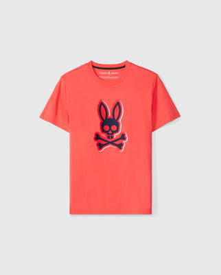 The KIDS KAYDEN GRAPHIC TEE - B0U676C200 by Psycho Bunny is a red tee made from soft Pima cotton and showcases a bold black and red graphic of a bunny with crossed bones underneath.