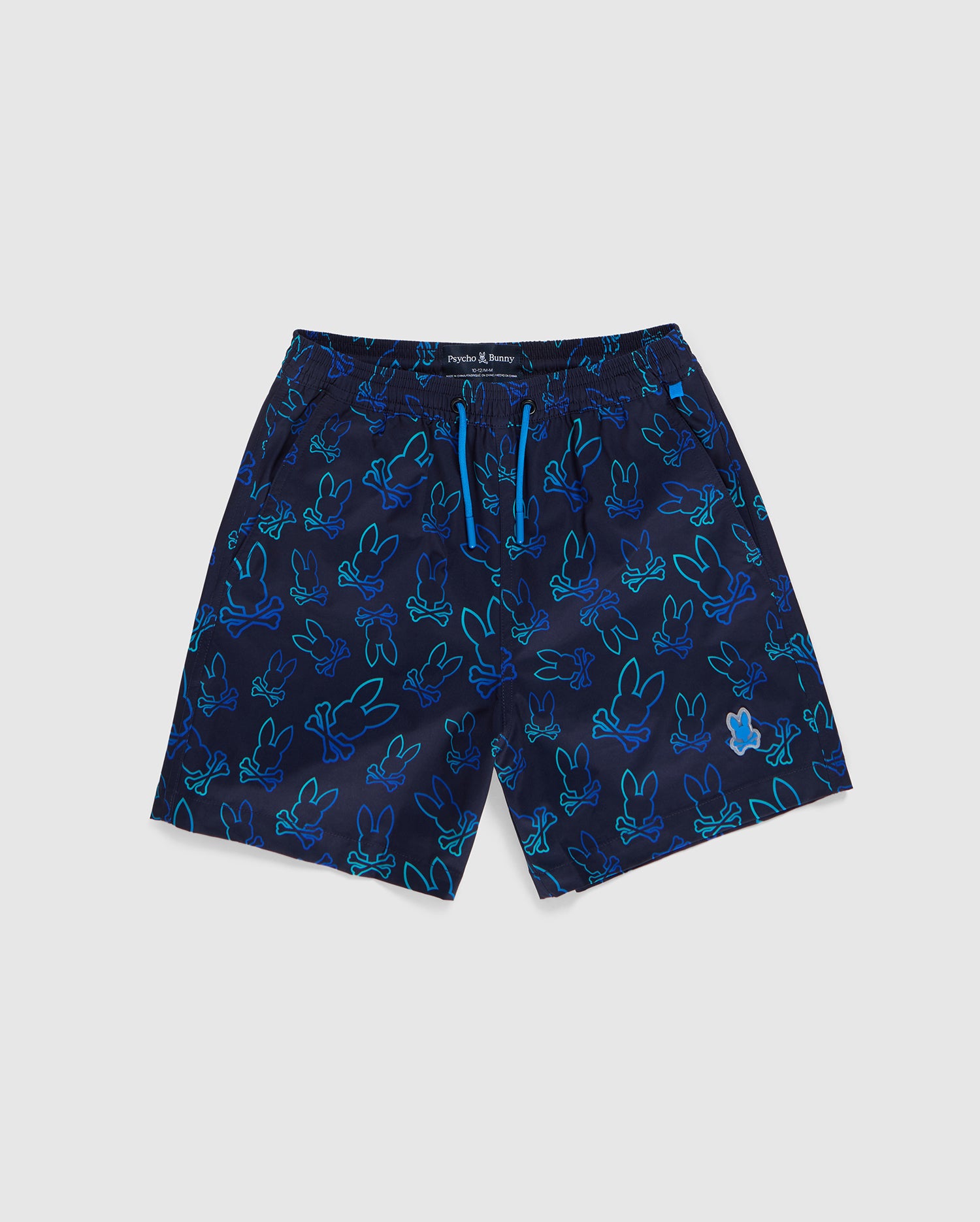 A pair of KIDS SHELDON ALL OVER PRINT SWIM TRUNK - B0W588C200 by Psycho Bunny featuring a vibrant bunny pattern of light blue and teal outlined bunnies in various playful positions. The quick-dry fabric shorts have an elastic waistband with an adjustable drawstring.