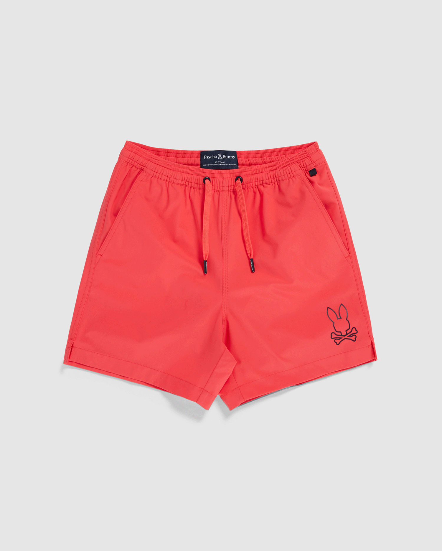 Bright red men's swim trunks featuring a black cartoon bunny with crossbones on the left leg. Made from quick-dry material, the KIDS PARKER HYDROCHROMIC SWIM TRUNK - B0W646C200 by Psycho Bunny has an elastic waistband with a drawstring, two side pockets, and a back pocket with a small black loop above it. Perfect for storing your waterproof bag.