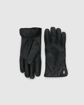 A pair of elegant MENS LEATHER GLOVES - B6A011E200 by Psycho Bunny is displayed against a plain background. One glove showcases the front with four fingers visible, while the other reveals the back with a subtle gathered design. A small logo is embroidered near the wrist, emphasizing their high-quality craftsmanship.