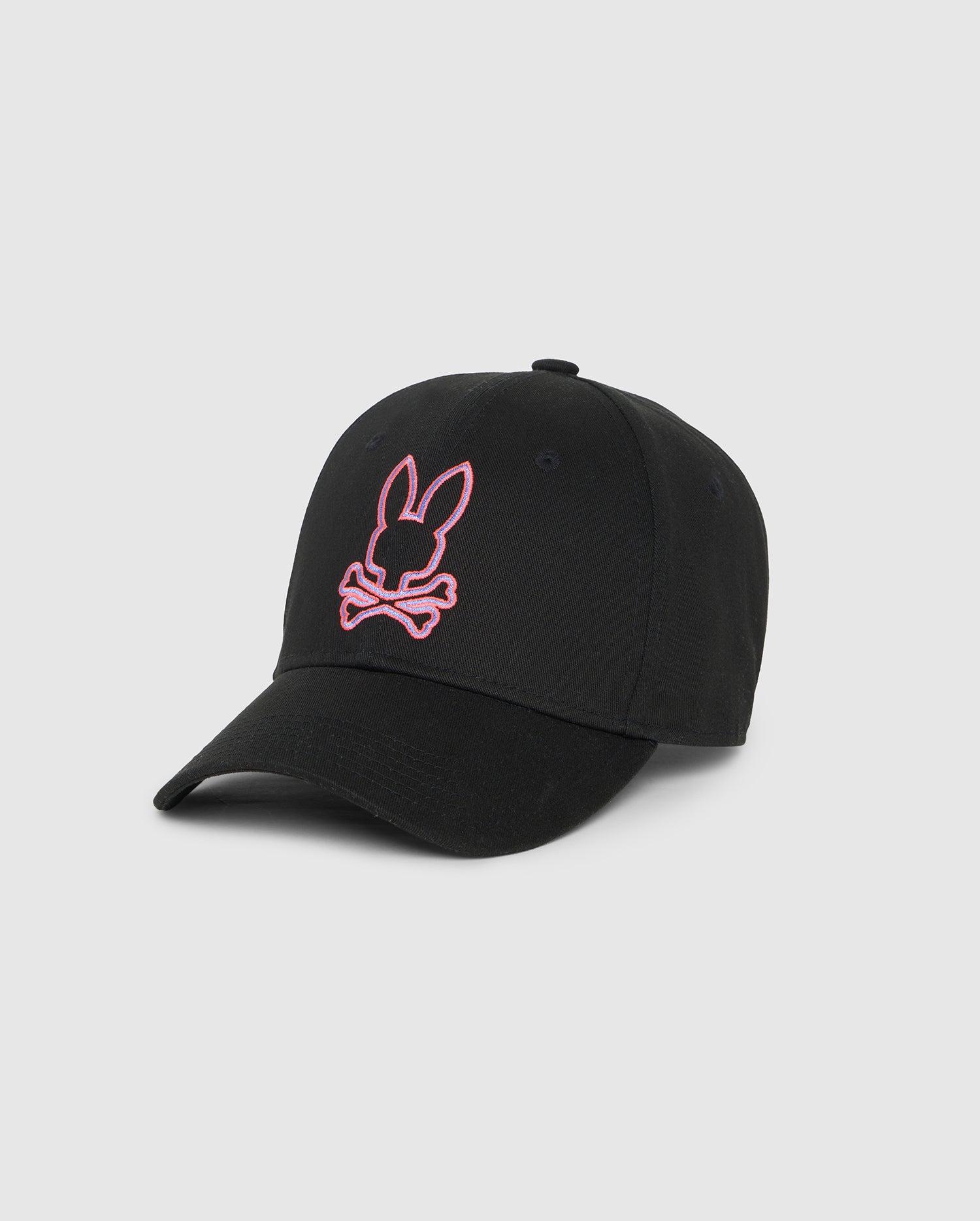 A Psycho Bunny MENS FLOYD BASEBALL CAP - B6A326B2HT made from durable cotton twill features a black design with a pink embroidered bunny head and crossed bones on the front. The cap, with its curved brim, stands out strikingly on a plain white background.