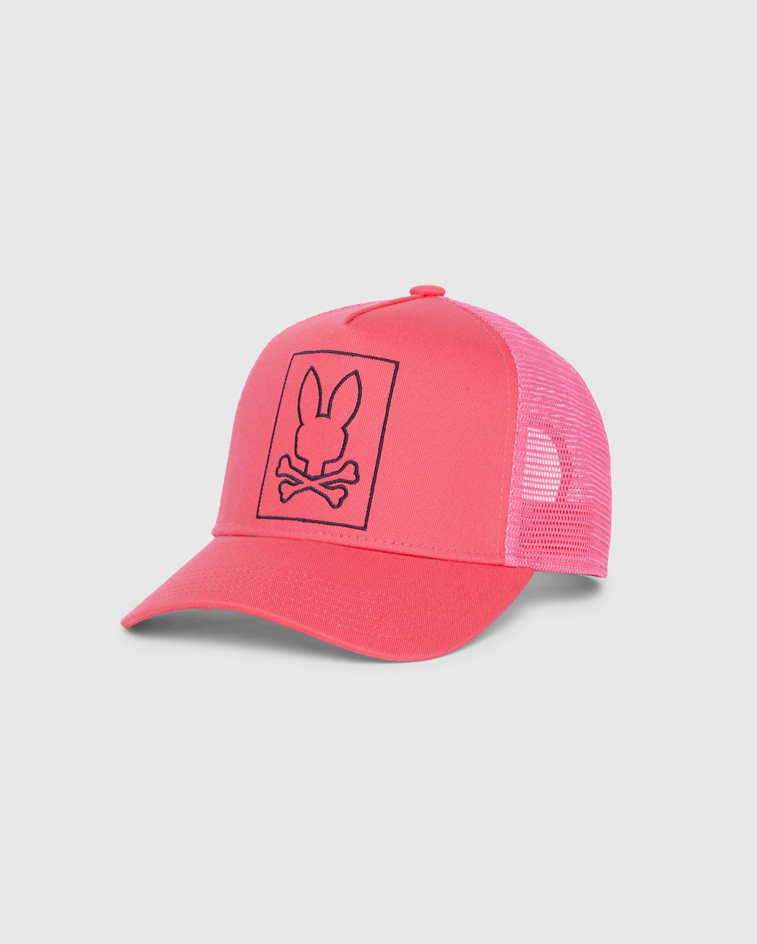 A vibrant pink MENS LIVINGSTON TRUCKER CAP - B6A401B200 with a mesh back and adjustable snapback fastening. The front panel features a black outline of a bunny head with crossbones underneath, giving the cap a unique and edgy look. Set against a plain white background, this bunny design truly stands out. This stylish cap is brought to you by Psycho Bunny.