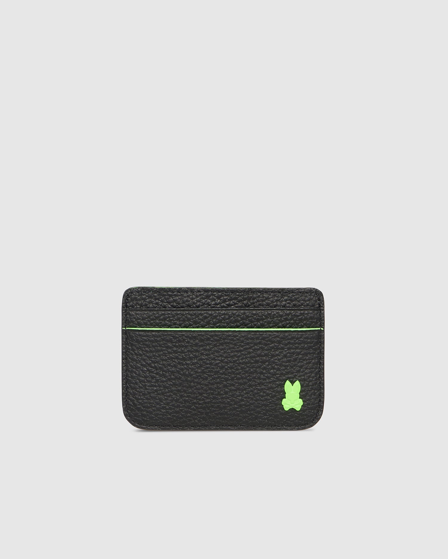A sleek black leather cardholder with a green stitched accent line across the top and a small green bunny patch in the bottom right corner against a plain white background, Psycho Bunny's CARD CASE - B6A409B200.