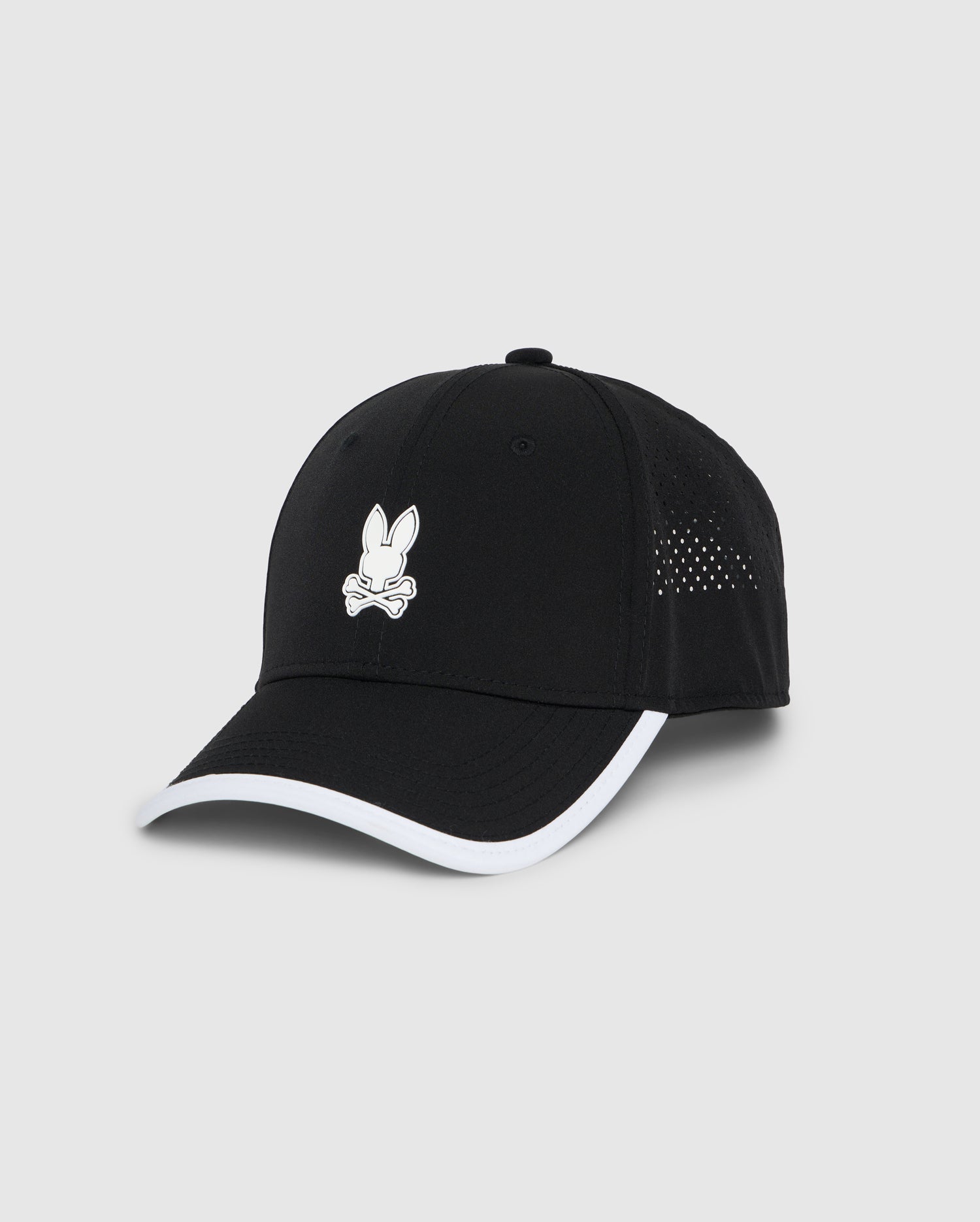 A black Psycho Bunny MENS LUCAS SPORT CAP - B6A590C200 featuring a white outline of a rabbit's head on the front. The performance-driven cap has white trim along the edge of the bill, small ventilation holes on the sides, and moisture-wicking fabric. The background is light gray.