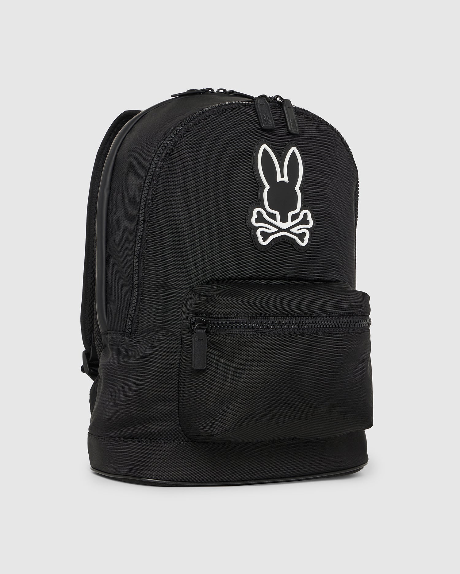 Black Psycho Bunny dome backpack featuring a distinct white bunny logo on the front, with a main compartment and a smaller front pocket, set against a plain white background.