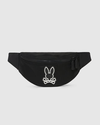 A black canvas Psycho Bunny hip bag with a white bunny logo embroidered on the front, featuring a main zippered compartment and an adjustable strap. The background is plain white.