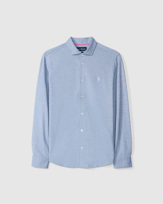 The Psycho Bunny DALTON MELANGE KNIT LONG SLEEVE SHIRT - B6C747D200 is a light blue button-up with a spread collar and a small embroidered logo on the chest, featuring long sleeves and neatly pressed, shown against a plain background.