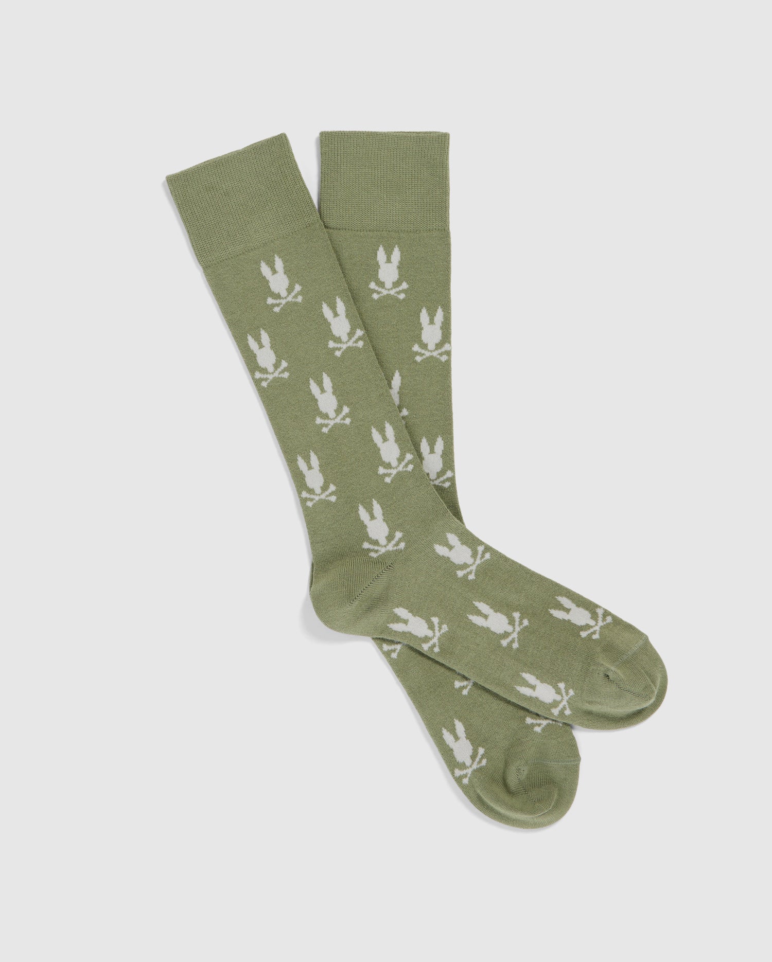 A pair of MENS DRESS SOCK - B6F750C200 by Psycho Bunny featuring a repeating white bunny pattern and crossed swords. Made from luxurious Peruvian Pima cotton, the socks are laid flat on a white background.