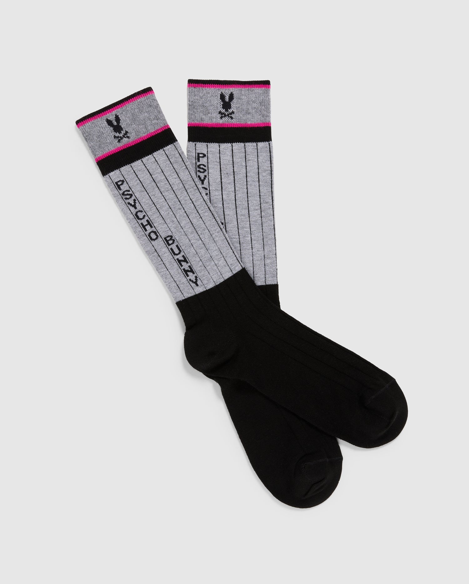 The MENS CONTRAST COLOR DRESS SOCK - B6F760D200 by Psycho Bunny features black feet and gray ribbed sections made from a Pima cotton-blend. Red stripes adorn the top, accompanied by a black rabbit head logo and the text 