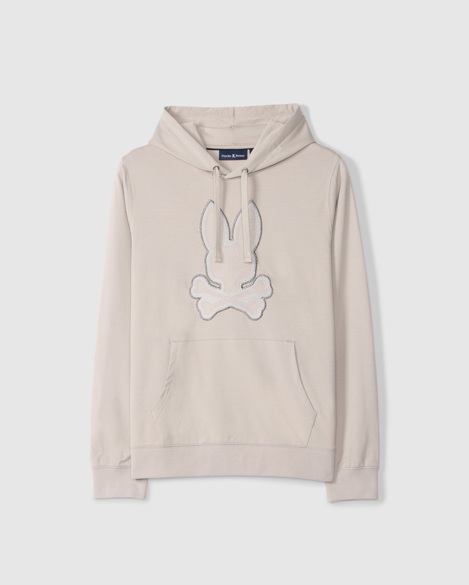 Introducing the MENS WALTER LIGHTWEIGHT HOODIE - B6H476D200 by Psycho Bunny: a light beige regular fit hooded sweatshirt crafted from Micro French terry. It features a front pocket and ribbed cuffs, with a unique design showcasing an embroidered bunny head with crossbones below it, in white and outlined in light blue on the front.