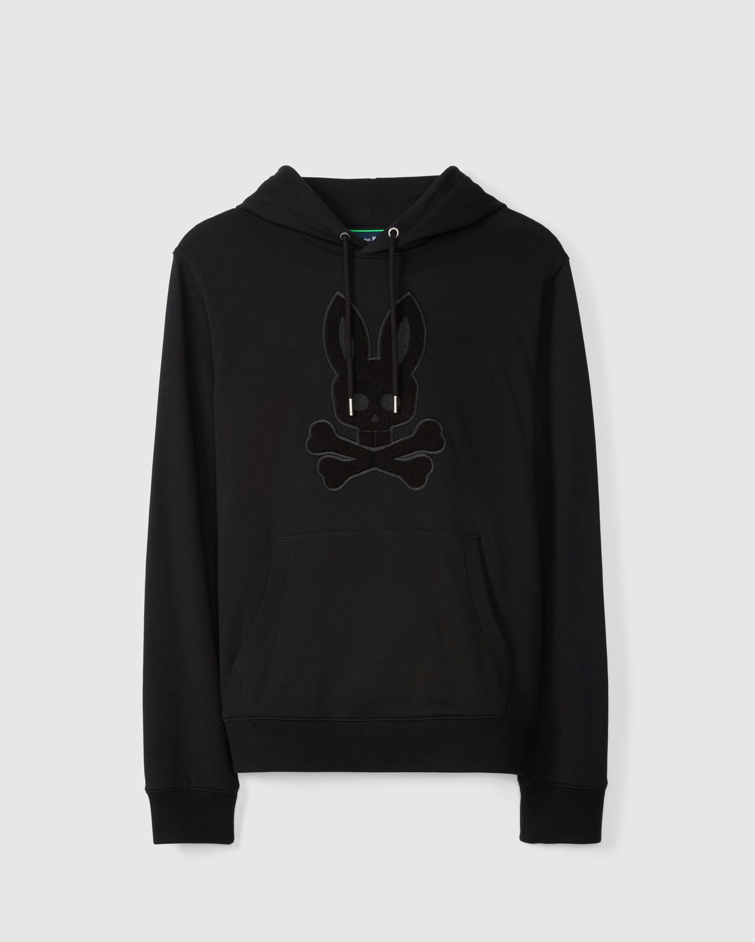 Introducing the Psycho Bunny Men's Pacific Chenille Hoodie (B6H930D200), a stylish black French terry hoodie adorned with a chenille-embroidered bunny skull and crossbones design on the front. It comes equipped with a drawstring hood and features a convenient kangaroo pocket, all set against its sleek design.