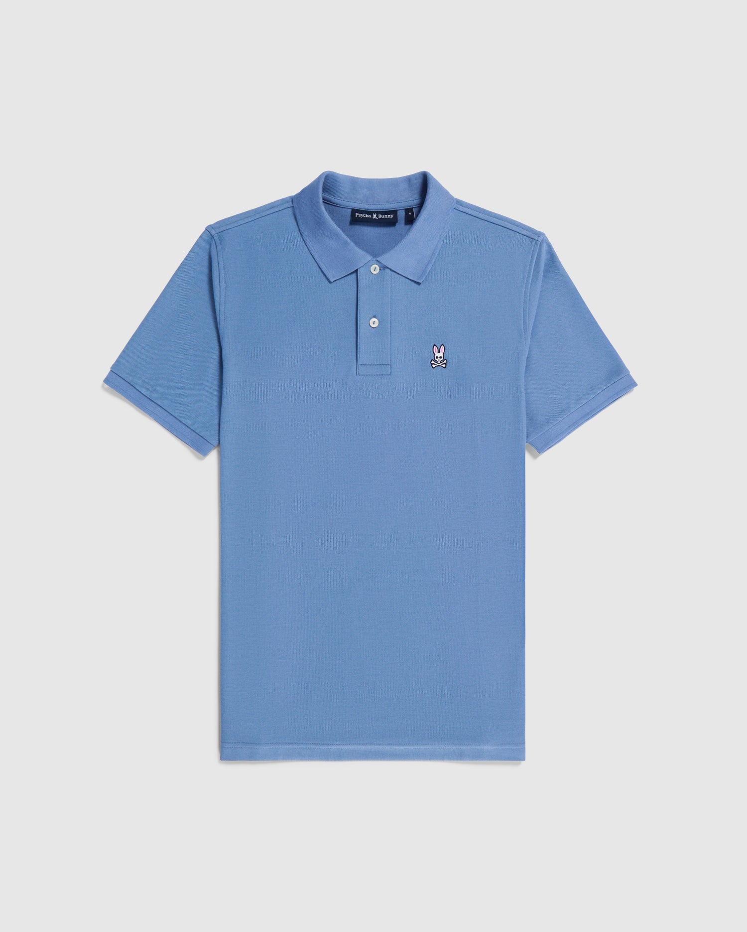 A light blue, short-sleeve men's MENS CLASSIC PIQUE POLO SHIRT - B6K001A2PC with a collar and buttoned placket. Crafted from premium Pima cotton, it features a small embroidered bunny logo on the left chest area. The regular fit shirt from Psycho Bunny is neatly laid out on a plain white background.