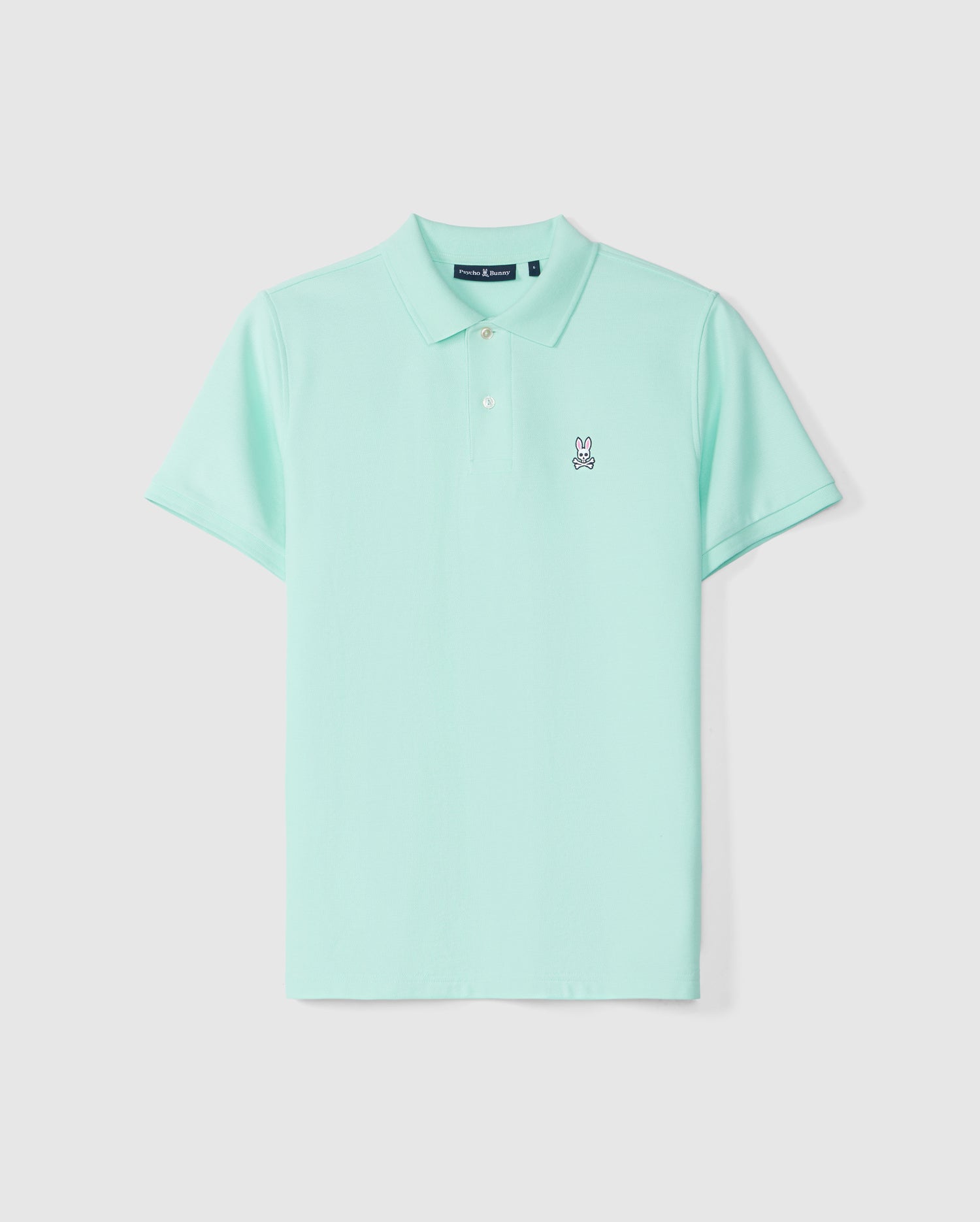 A mint green Psycho Bunny pima cotton polo shirt displayed against a plain background, featuring three buttons and a small white bunny logo on the left chest area.