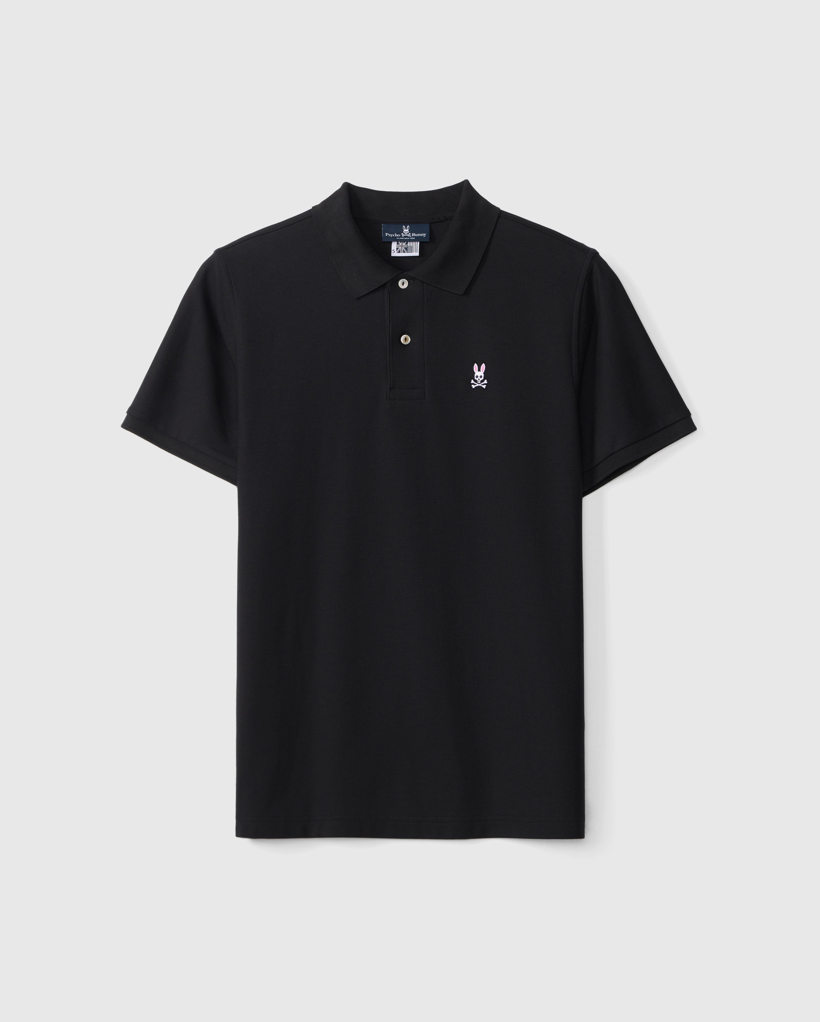 The Psycho Bunny Men's Classic Pique Polo Shirt (B6K001ARPC) in black is made from 100% Pima cotton and features a small embroidered logo with a white outline and pink interior on the left chest. It includes a three-button placket and short sleeves, displayed against a light gray background.