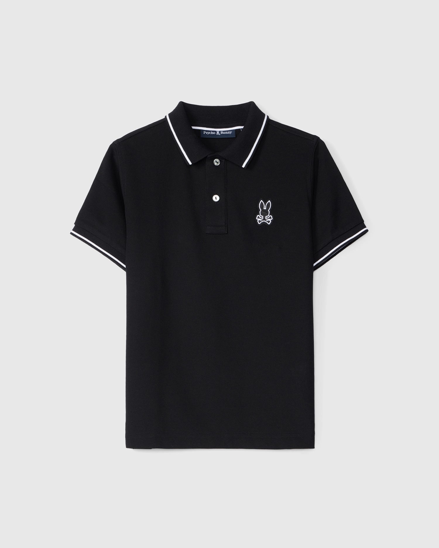 A black Pima cotton polo shirt with white tipping on the collar and sleeves. It features a three-button placket with mother-of-pearl buttons and an embroidered Bunny logo on the left chest. The Psycho Bunny MENS LENOX PIQUE POLO SHIRT - B6K138B200 is displayed on a plain white background.