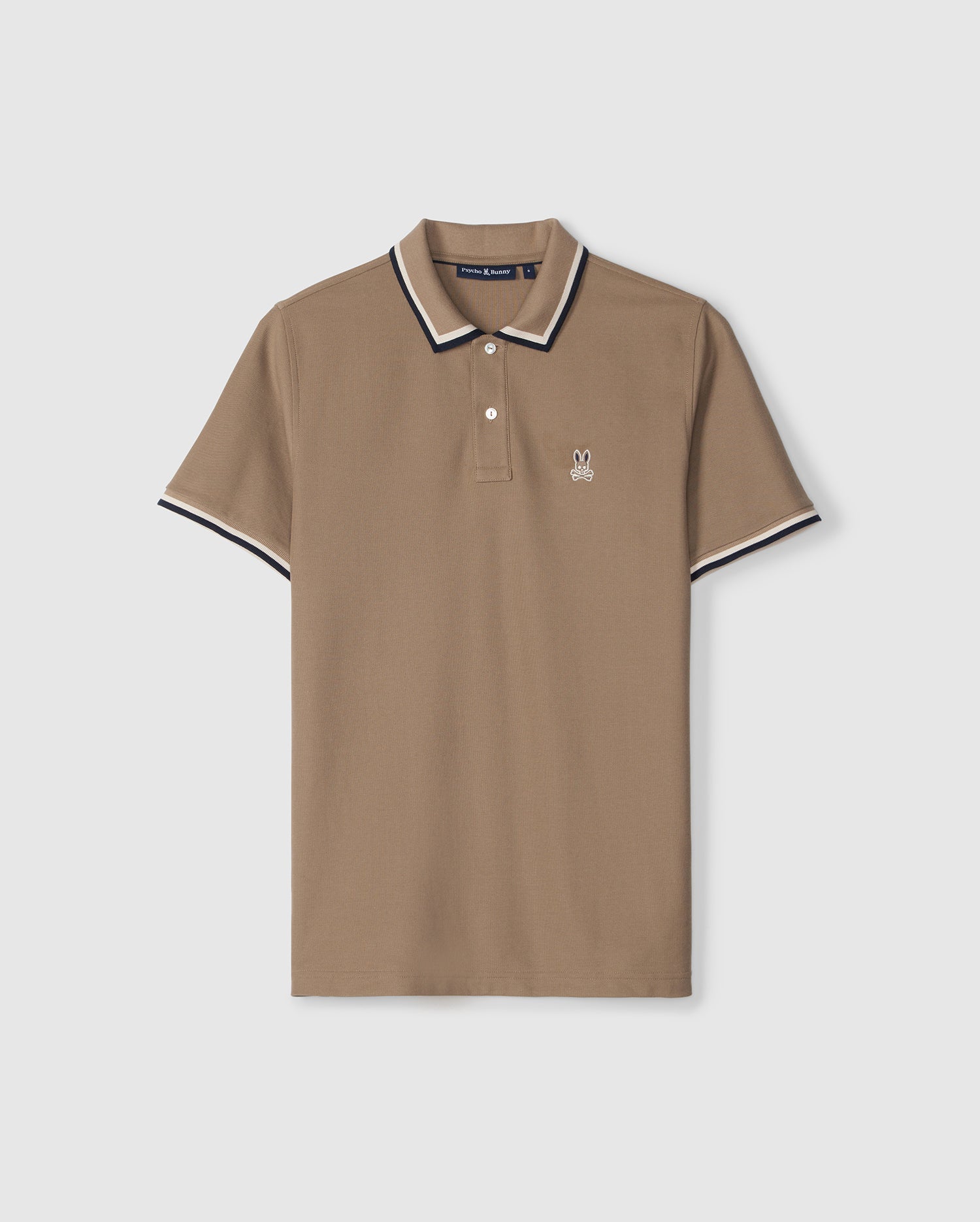 A taupe Psycho Bunny Kingsbury piqué polo shirt with contrasting stripes on the collar and sleeves, featuring a small embroidered logo on the left chest, displayed on a plain background.