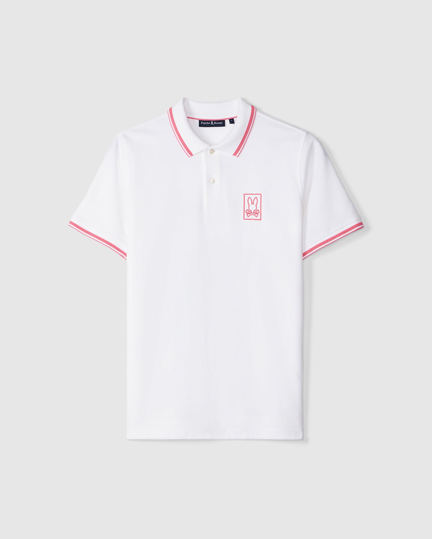 Psycho Bunny Men's Arcadia Pique Polo Shirt - B6K406B200, white shirt with red and navy trim on the collar and sleeves, featuring a small pink bunny logo on the left chest. The shirt is displayed against a plain, light background.