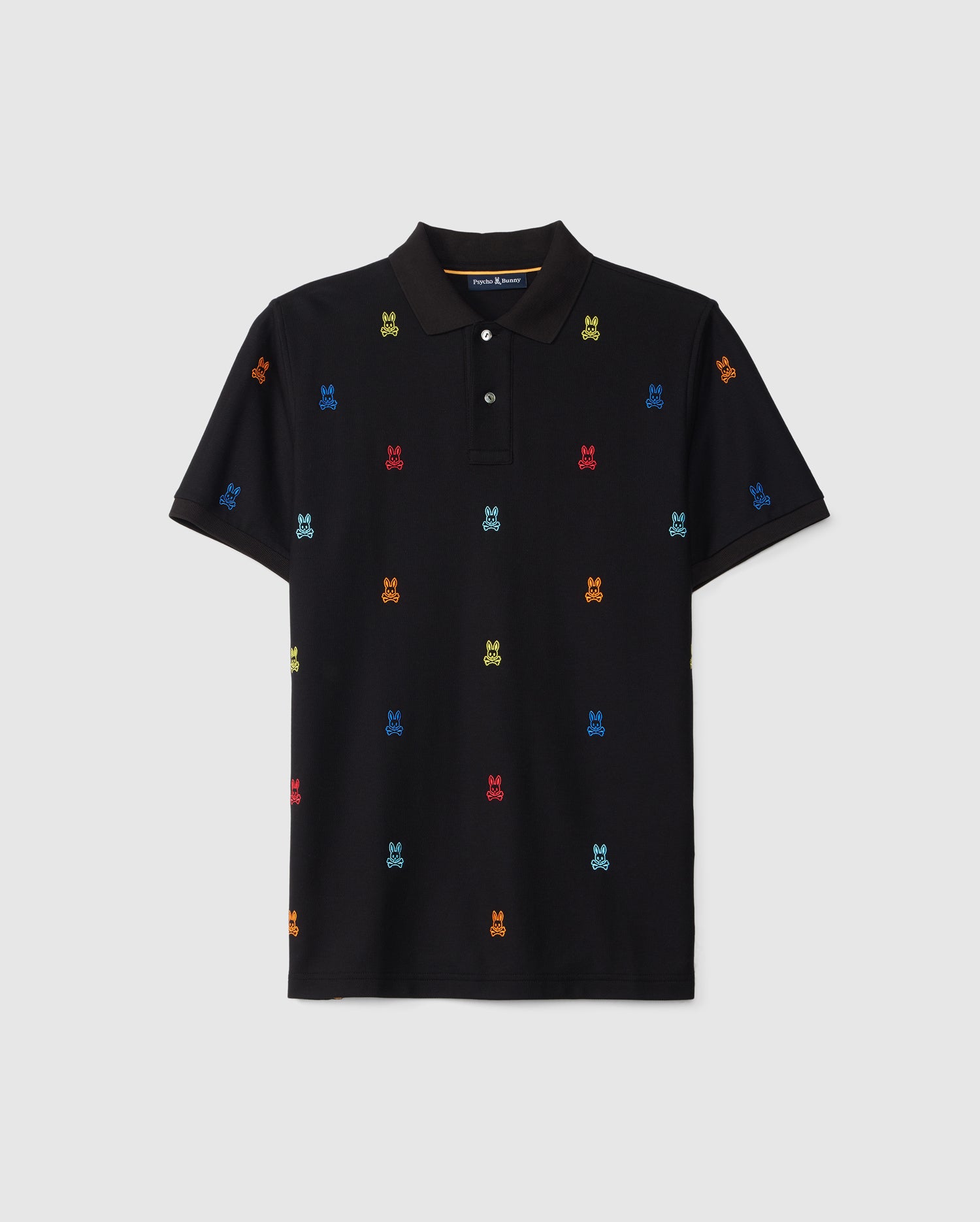 A black short-sleeve MENS BONHAM PIQUE POLO - B6K501C200 featuring a classic collar and button-down front. The ultra-soft Pima cotton fabric displays a multicolor jacquard pattern of small, colorful, embroidered dog faces in red, blue, green, and yellow, evenly spaced across the shirt. This stylish piece is from Psycho Bunny.