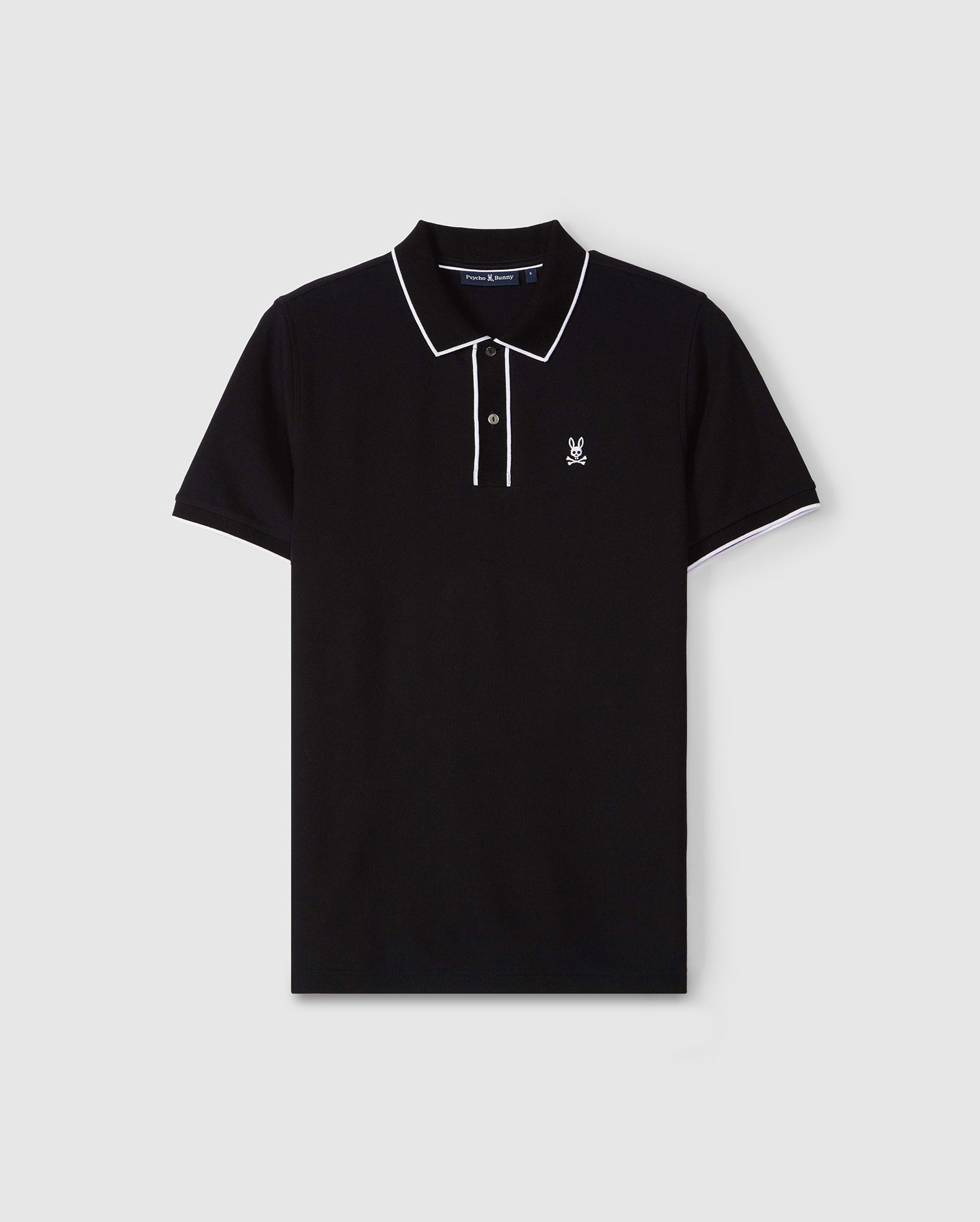 A black Psycho Bunny MENS DALLAS PIQUE POLO SHIRT - B6K602C200 with white trim on the collar and sleeve edges. It features an embroidered Bunny logo on the left chest and has a buttoned placket with genuine mother of pearl buttons. The shirt is displayed against a plain light gray background.