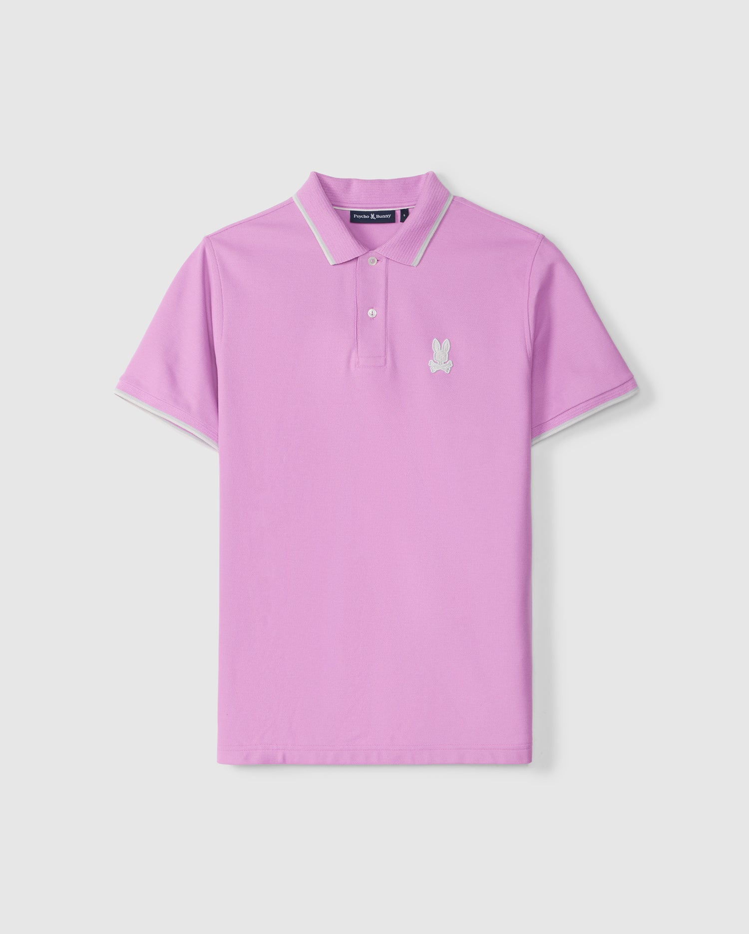 A purple MENS HOUSTON PIQUE POLO SHIRT - B6K604C200 with a collar and white trim on the sleeve edges. It features an embroidered white bunny logo on the left chest, showcasing its luxury finishes by Psycho Bunny.
