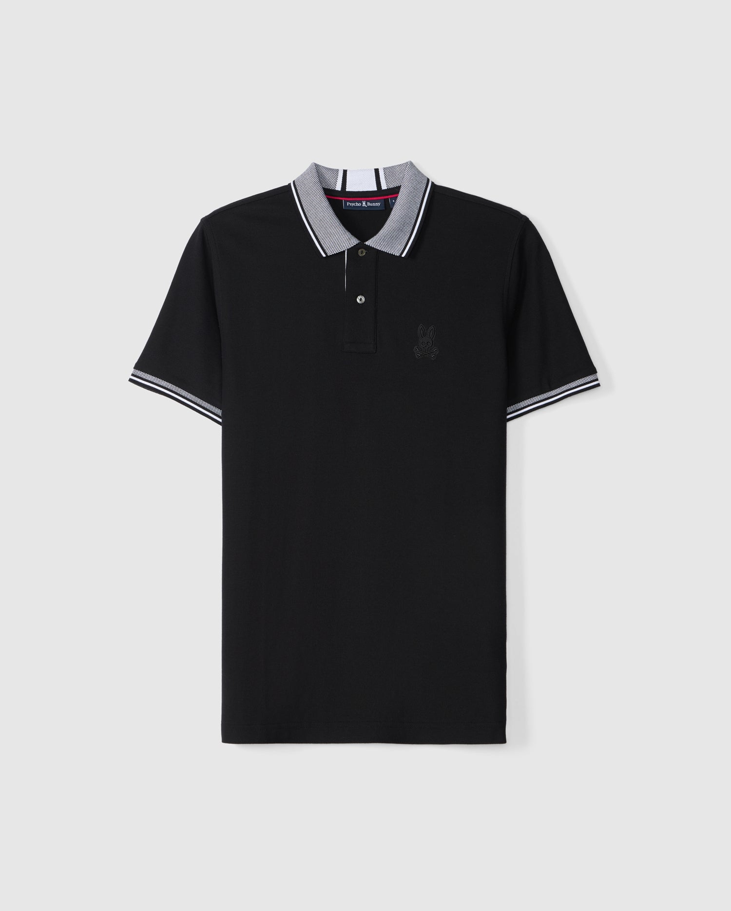 The Psycho Bunny Men's Malton Pique Polo Shirt (B6K950D200) is spread out flat against a plain white background, showcasing its black Pima cotton fabric. This short-sleeve polo features a two-button placket, a gray collar, and sleeve cuffs with white stripes. The left chest area is adorned with an embroidered Psycho Bunny graphic.