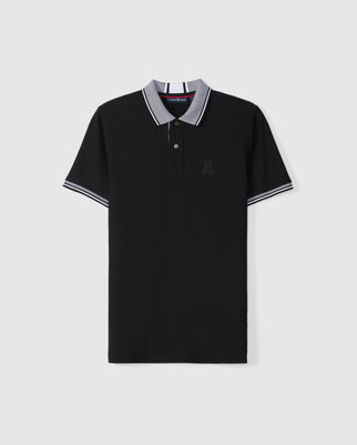 The Psycho Bunny Men's Malton Pique Polo Shirt (B6K950D200) is spread out flat against a plain white background, showcasing its black Pima cotton fabric. This short-sleeve polo features a two-button placket, a gray collar, and sleeve cuffs with white stripes. The left chest area is adorned with an embroidered Psycho Bunny graphic.