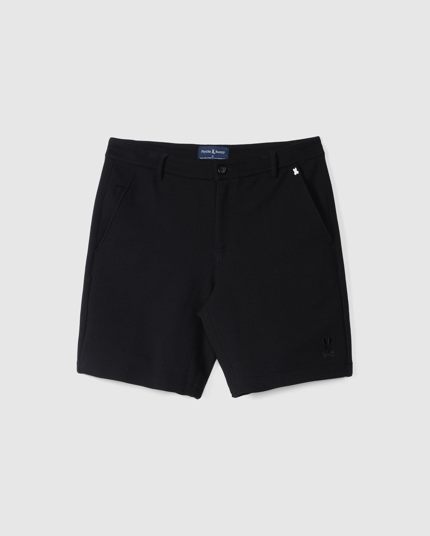 Black tailored shorts with a button and zip closure, displayed flat on a neutral background, featuring discreet side pockets and a small visible Psycho Bunny logo on the left leg. These MENS SHIRO KNIT HONEYCOMB SHORT - B6R567C200 boast a structured texture for added detail.