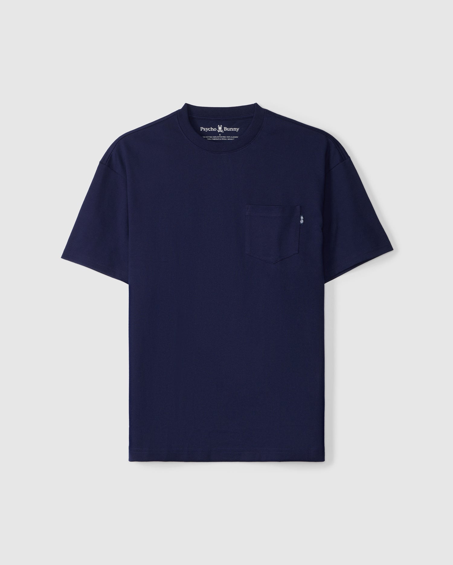 The MENS CLYDE OVERSIZED POCKET TEE - B6U012D200 by Psycho Bunny is a navy blue crew neck t-shirt featuring a small chest pocket on the left side. Crafted from luxurious Peruvian Pima cotton for ultimate softness, this relaxed fit t-shirt is showcased against a plain white background.