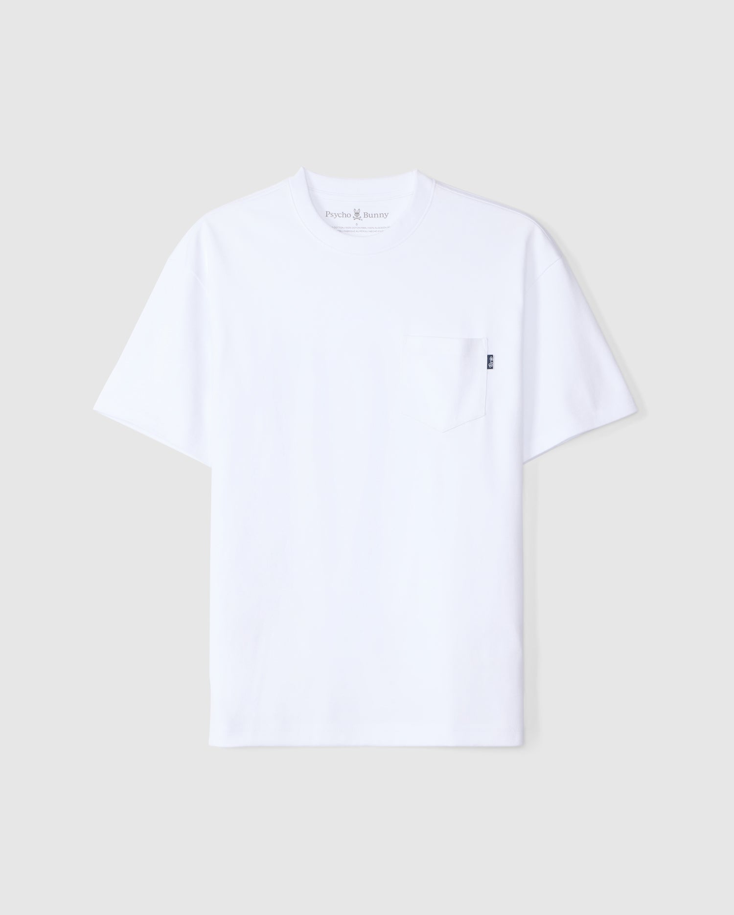 A plain white short-sleeve T-shirt made from Peruvian Pima cotton, featuring a crew neck and a small chest pocket on the left side. The T-shirt is displayed flat against a plain light gray background. This item is the MENS CLYDE OVERSIZED POCKET TEE - B6U012D200 from Psycho Bunny.