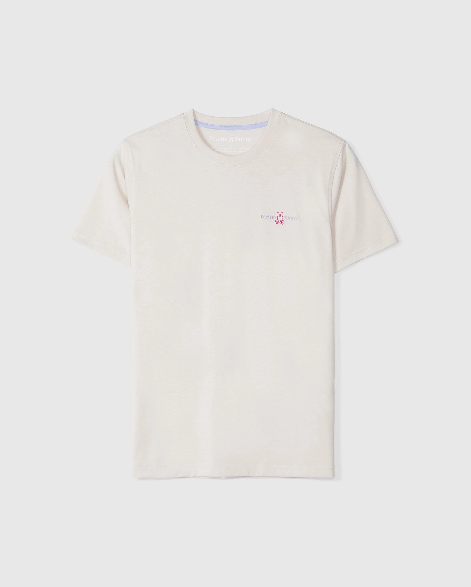 A plain cream-colored t-shirt made of Peruvian Pima cotton with a small pink heart emblem and the text 