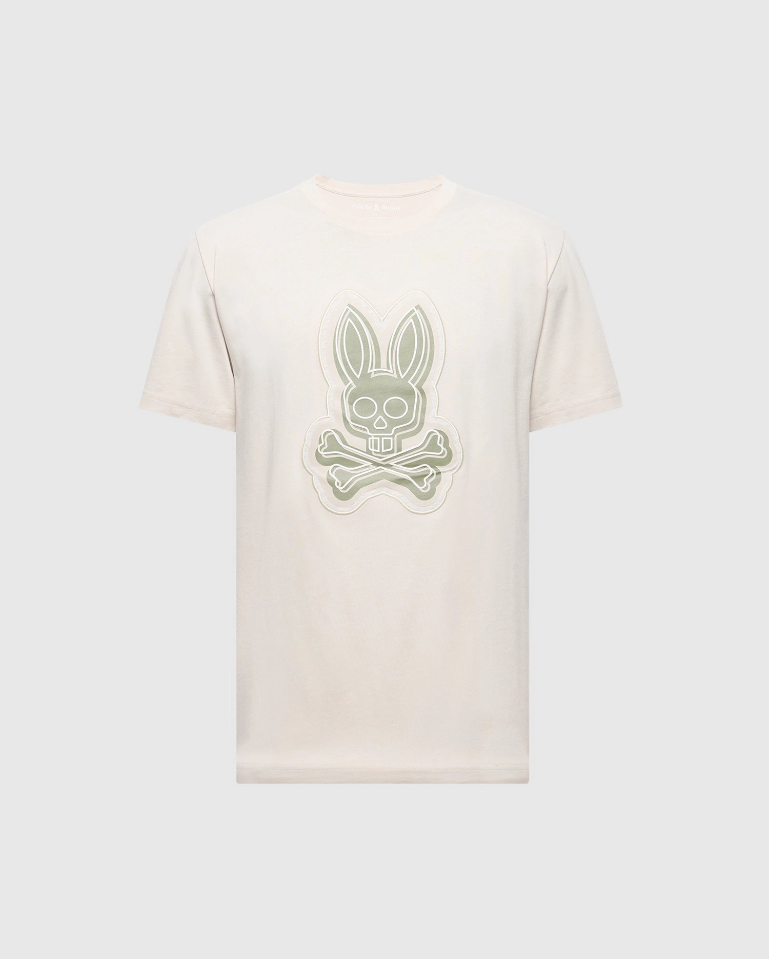 The MENS SYDNEY GRAPHIC TEE by Psycho Bunny features a cream-colored Pima cotton design with a stylized gray bunny and crossed bones logo on the front, set against a light gray background.