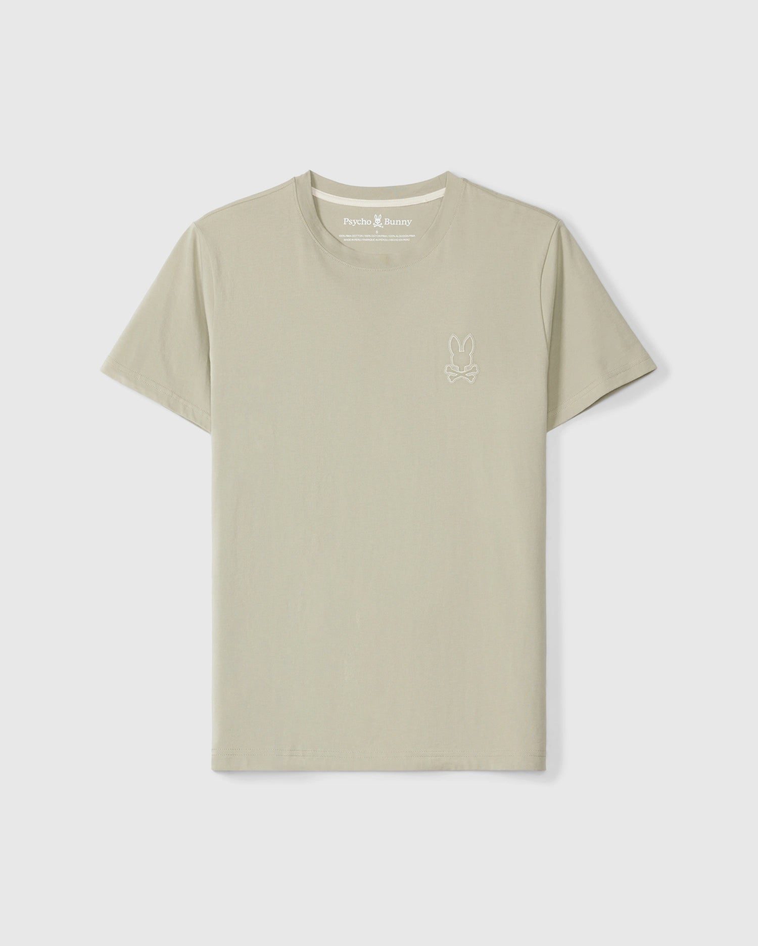 The Pearland tee, a light beige short-sleeved t-shirt crafted from soft Pima cotton, features the Psycho Bunny's small embroidered bunny logo on the upper left side of the chest. The shirt, officially named MENS PEARLAND BACK GRAPHIC TEE - B6U632C200, is displayed against a plain white background.