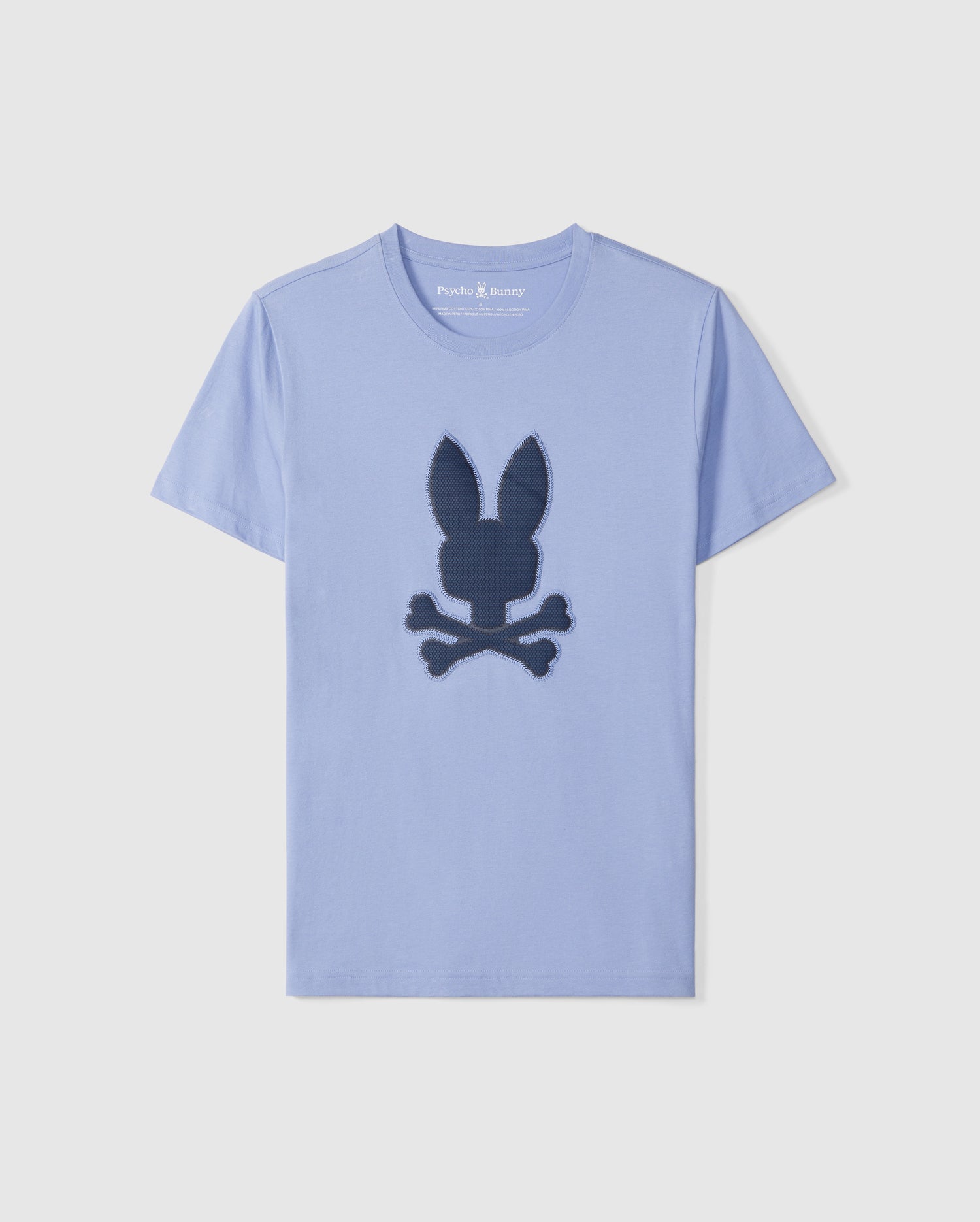 A light blue short-sleeve graphic tee with a large dark blue logo on the front. The logo features the silhouette of a bunny head with ears pointing up, positioned over a pair of crossed bones. Made from premium Peruvian Pima cotton, the neckline boasts 