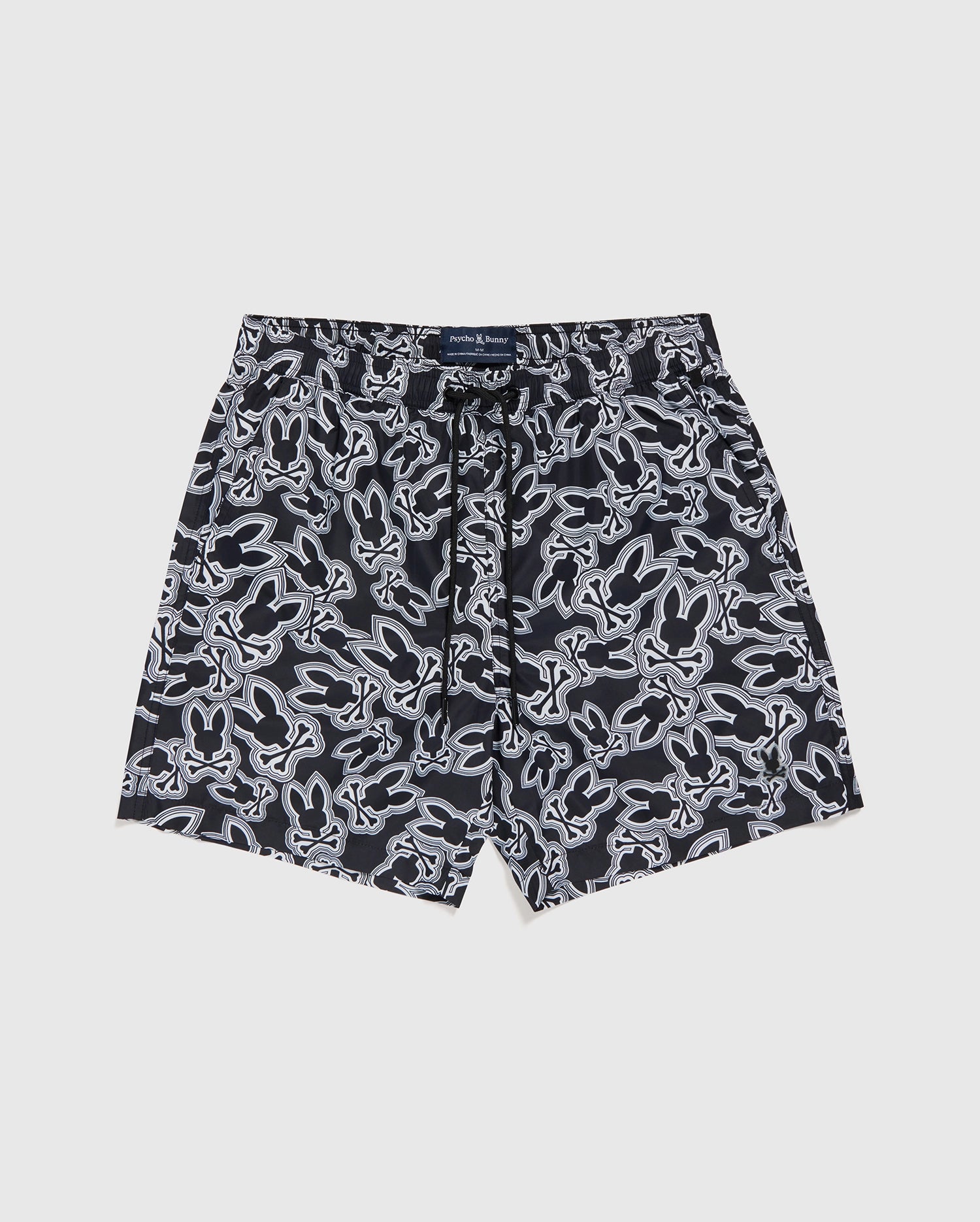 Swim trunks with a dark blue base and white tropical floral patterns, crafted from recycled polyester, displayed flat on a white background. Psycho Bunny's MENS MAYBROOK LIGHTWEIGHT SWIM TRUNK - B6W119B2SW.