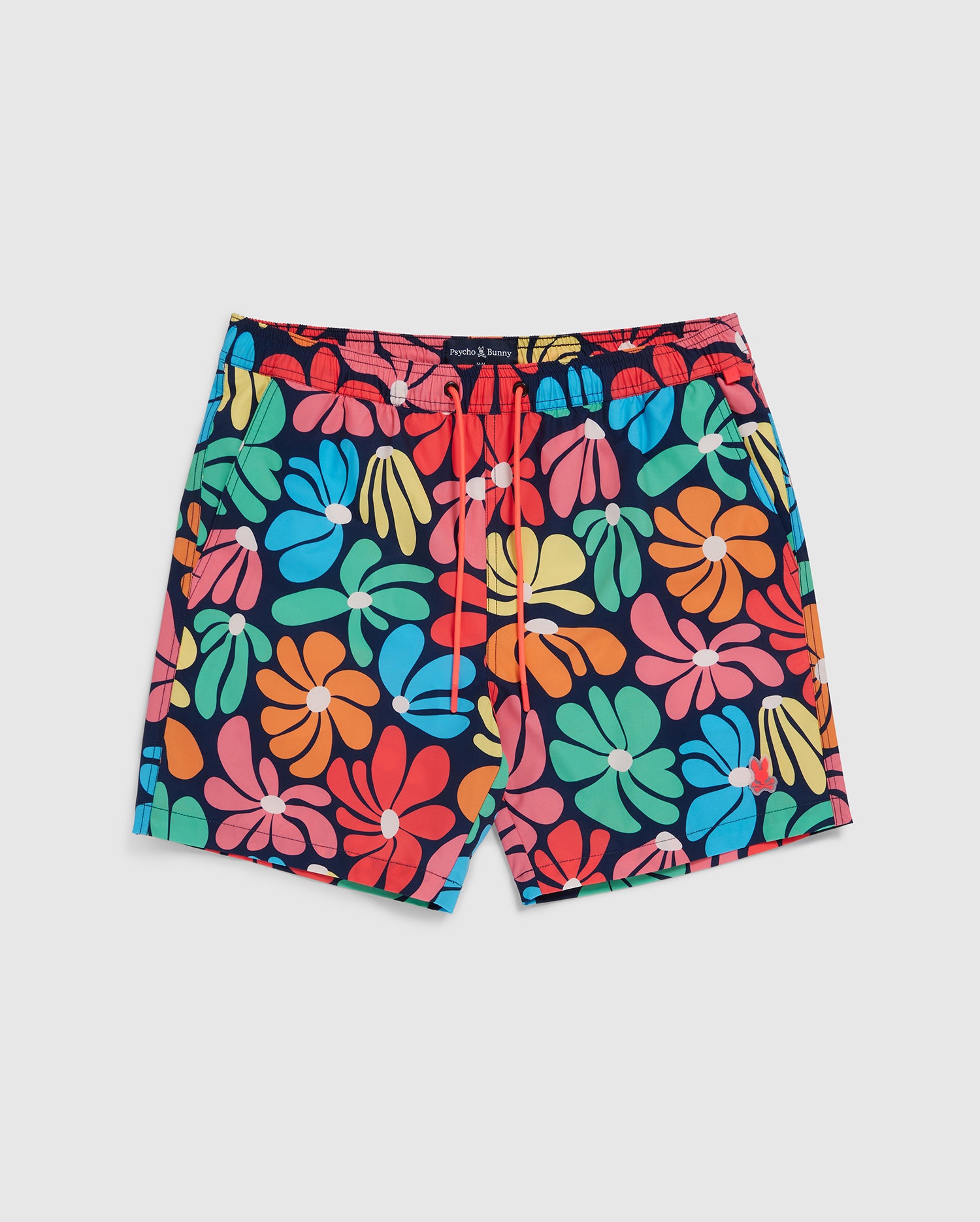A pair of Psycho Bunny MENS MENTZ SWIM TRUNK - B6W320B2SW featuring large, vibrant flowers in shades of blue, green, yellow, pink, orange, and red. The shorts have an elastic waistband with a red drawstring for adjustment. The quick-dry swim trunk has a white background.