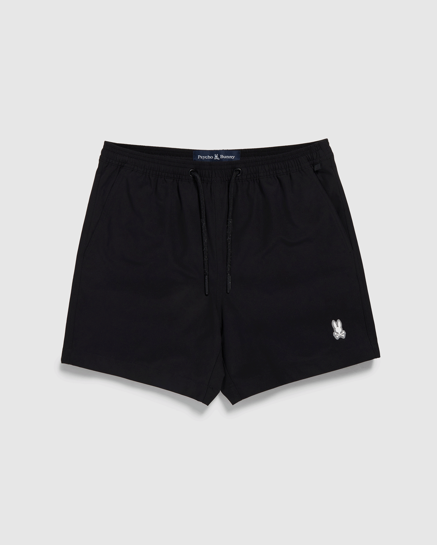 Black Psycho Bunny swim trunks with a drawstring and a small white logo on the left leg, displayed against a white backdrop. The label 