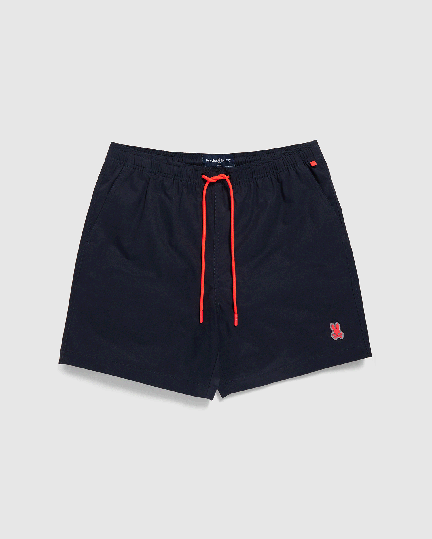 Navy blue Psycho Bunny swim trunks with a red drawstring and a small red emblem on the left leg, displayed against a white background.