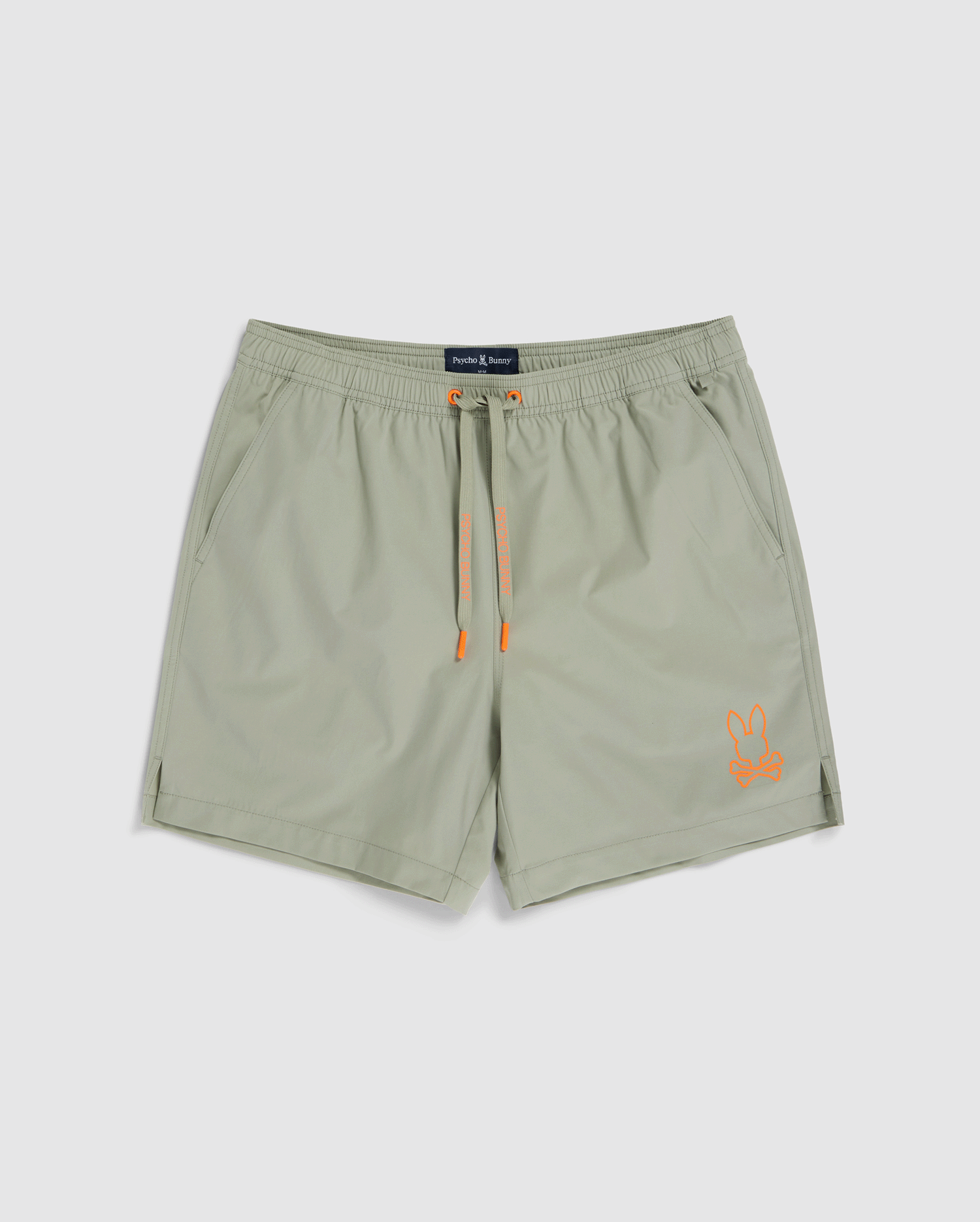 Light gray **MENS PARKER HYDROCHROMIC SWIM TRUNK - B6W646C200** with a drawstring waistband and orange accents. The quick-dry material ensures swift evaporation, making them ideal for swimming. Featuring a small, orange bunny logo on the lower left leg and a brand tag inside the waistband, these **Psycho Bunny** shorts offer both style and functionality.